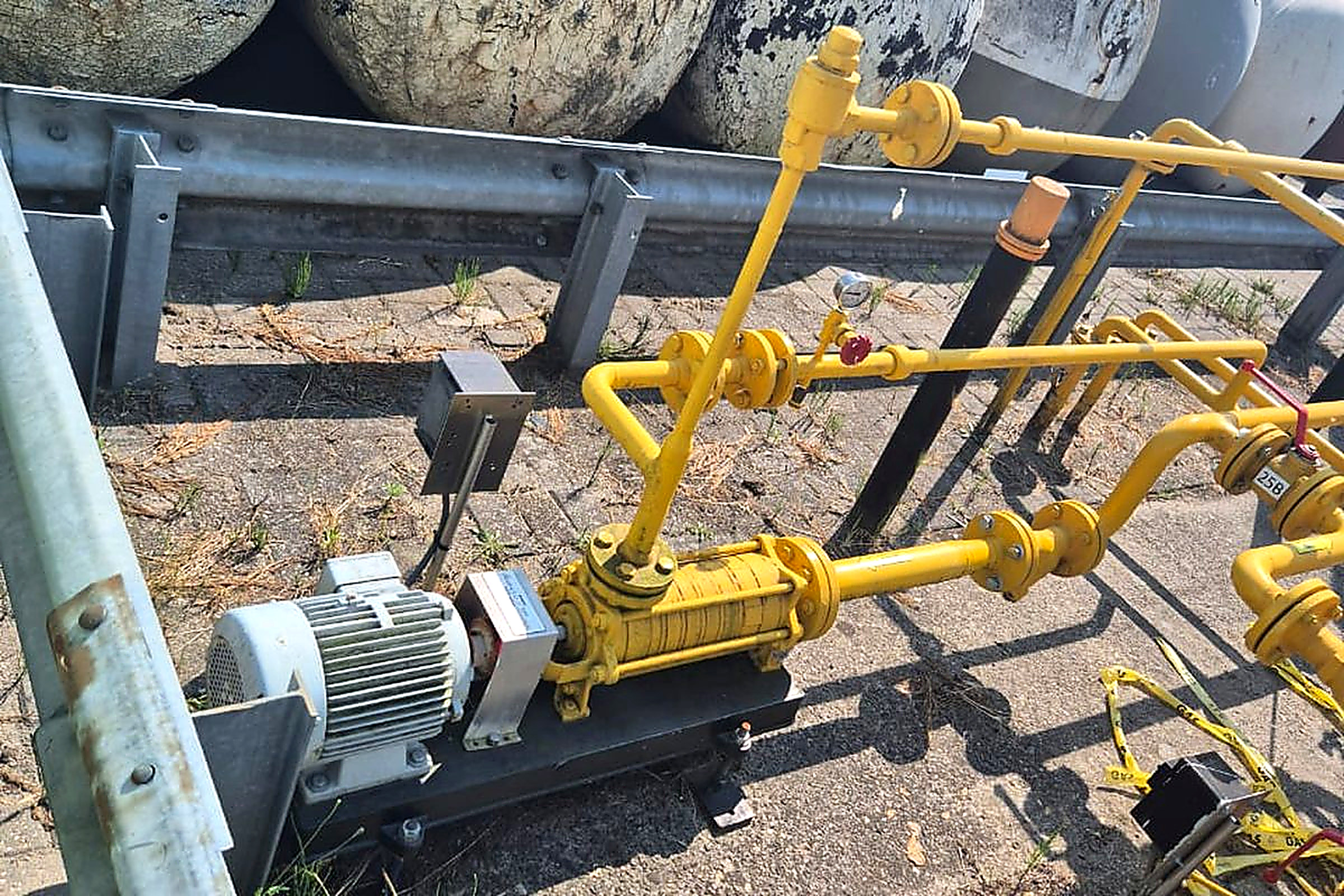 A yellow LPG plant skid with pumping units installed at a Bomart site